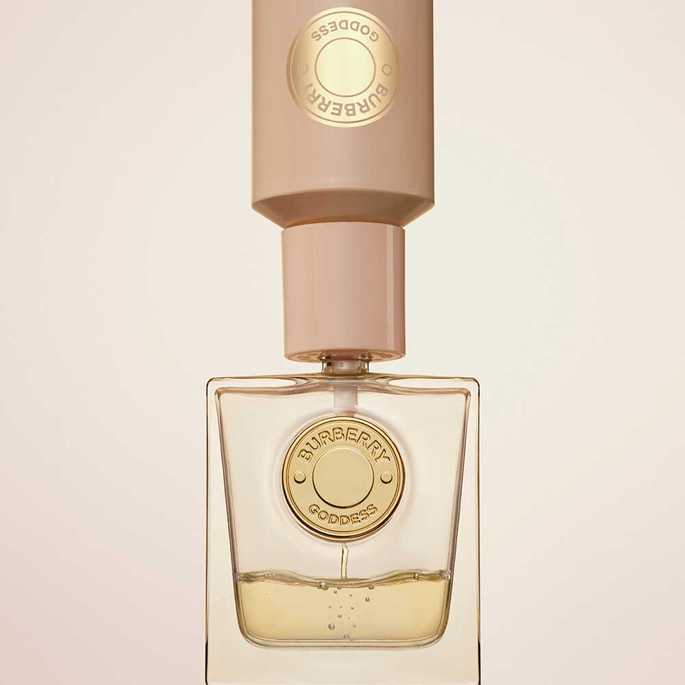 Image of refill bottle being used to refill empty perfume bottle